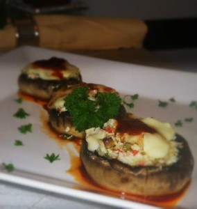 Stuffed Portobello Mushroom with Roasted Red Pepper Coulis, Basil Pesto and Fried Onions